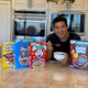 Mario Lopez eating a bowl of Cocoa Puffs in his kitchen, smiling